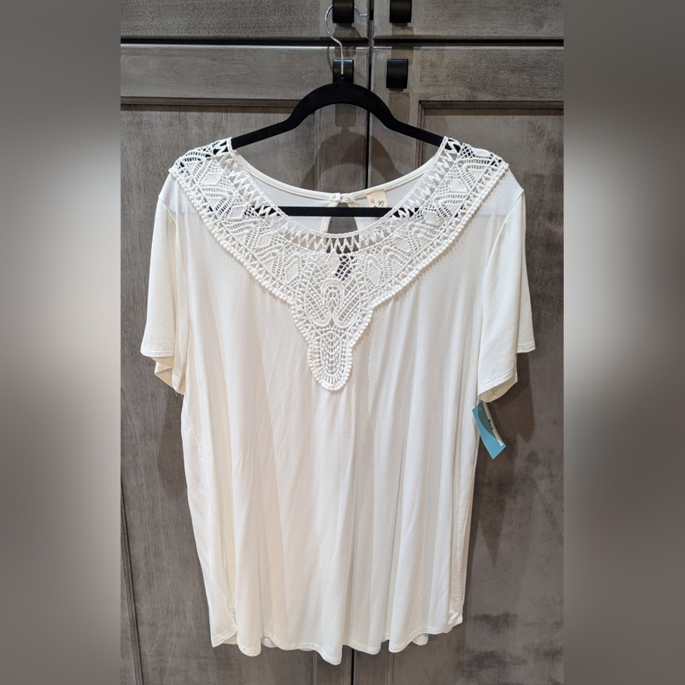 Seventh row white top with tags